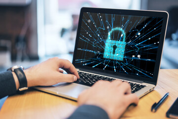 Poster - Close up of male hands at office workplace using laptop with abstract glowing padlock hologram. Secure, safety and data protection concept.