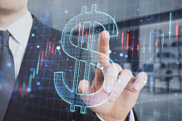 Poster - businessman hand pointing at creative glowing dollar sign hologram with forex chart on blurry office interior background. Money, trade, market, online banking app, currency and finance concept. 