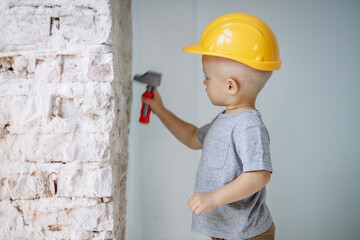 Cute little boy with toy building tools