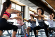 © NDABCREATIVITY - Group of fit people working out in a gym. Multiracial friends exercising together in fitness club.