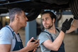 © zinkevych - Two skilled mechanics checking the car tires