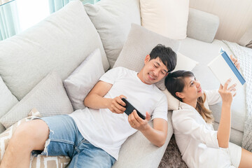 happy couple relax sitting having conversation on couch. husband and wife support each other make themselves relax in living room. handsome boyfriend and beautiful girlfriend having a conversation