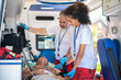 © zinkevych - Team of paramedics checking the patient vital signs