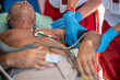 © zinkevych - Paramedical staff checking the vital signs of an ill man