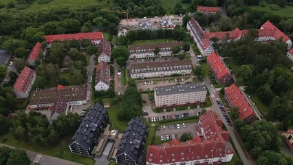 Wall Mural - Residential complex in small town, aerial view. Living houses with parked cars near green park