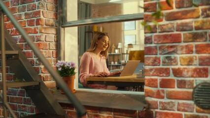 Aufkleber - Beautiful Caucasian Girl Using a Laptop Computer while Sitting Behind a Desk in Brooklyn Style Brownstone House. Young Female Browsing Internet, Checking Social Media, Shopping Online.