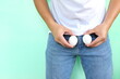 Men reproductive and male testicle health concept. Young asian man holding two chicken eggs on crotch area.