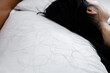 © doucefleur - closeup hair loss fallen on pillow with blur background of woman sleeping in bed