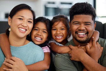 Poster - Family, smile and love of children for their mom and dad while sitting together in the lounge at home sharing a special bond. Portrait of happy Filipino man, woman and girl kids hugging their parents