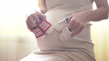 Pregnant Wife. Family Pregnancy Expecting A Baby. Woman Expecting The Birth Of A Newborn Baby. Baby Shoes On Belly Pregnant Woman. Pregnancy Child Care. Mothers Day Lifestyle