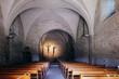 view on the sober and dark romanesque interior of Saint Agnes priory in Saint Jean de Galaure in Drome (France)