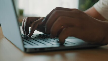 Close up male hands of unrecognizable African Latina male man at table typing laptop keyboard online work studying remote with computer app bet business chatting texting crypto currency project in net