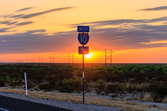 A shot of the I-10 roadsign at sunset in the west texas desert
