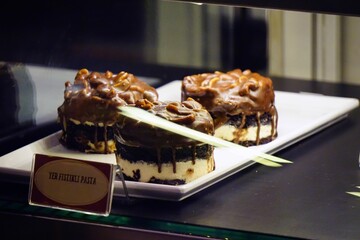 Poster - Closeup of delicious chocolate peanut cakes in the glass showcase