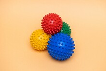 Spiky Massage Balls. Physiotherapy Balls. Dog Chewing Balls On Orange Background.