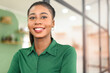 Portrait of confident African-American businesswoman standing with arms crossed, multiracial female office employee in smart casual wear looking at the camera and smiles