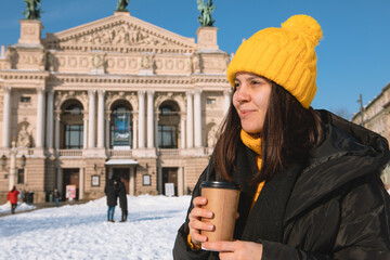 Poster - young woman with disposable cup drinking coffee