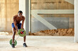 © Georgii - Athletic black young man lifting a heavy-weight barbell in outdoor gym under the bridge. Healthy lifestyle concept
