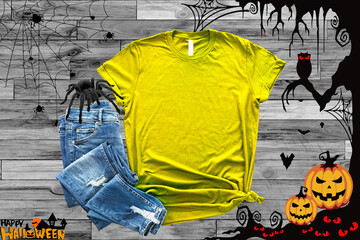 Wall Mural - Mockup of a halloween Yellow T-Shirt Blank Shirt Template Photo with Fall accessories and wooden background halloween shirt mockup
