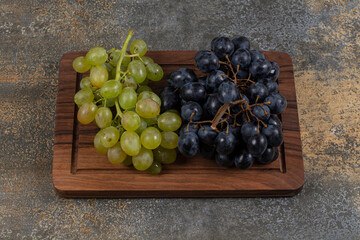 Mix fresh grapes on wooden board