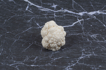 Wall Mural - Fresh Cauliflower on black stone background