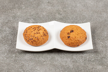 Two homemade fresh cookie on white plate