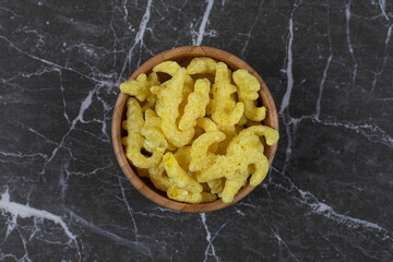 Wooden bowl of sweet cereal on marble background