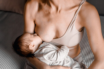 mom, mummy, young mother with little baby daughter. breast-feeding. mum feeding child with breast mi