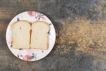 Two slices of bread on colorful plate