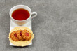 Cup of tea and jelly biscuits on saucer