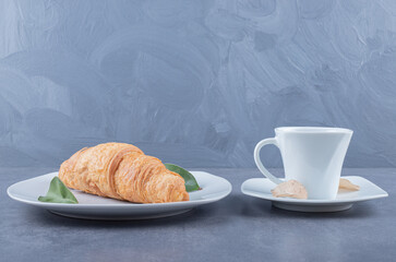 Wall Mural - Cup of Cappuccino and croissant for breakfast on grey background