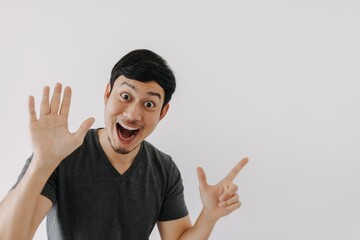 Wall Mural - Wow surprise shock face Asian man in black t-shirt isolated on white background.