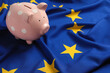 Pink piggy bank on European Union flag