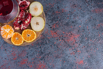 Wall Mural - Fresh season fruits with fresh glass of pomegranate juice on wooden board