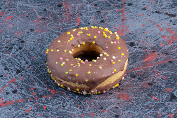 Wall Mural - Close up view of chocolate donut on colorful background