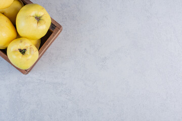 Wall Mural - Fresh quince apple in wooden basket