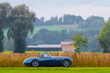 © Gaschwald - Oldtimer vintage luxury roadster sports car in a picturesque landscape. Vintage cabrio on a country road on a sunny summer day. Retro travel, traffic concept.