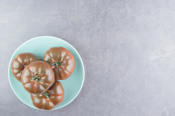 A Display of tomato in the plate , on the marble background