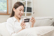 © KMPZZZ - Online internet banking, asian young woman hand in payment spending by scan qr code, use phone, mobile to transfer money or pay money of credit card without cash at home. Technology of financial.