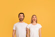 © Prostock-studio - Emotions of great ad and offer. Shocked happy young caucasian woman and man in white t-shirts with open mouths