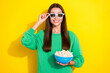 Photo of pretty positive lady hand touch glasses toothy smile hold popcorn isolated on yellow color background