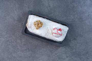 Wall Mural - Cookie with grated coconuts on black plate