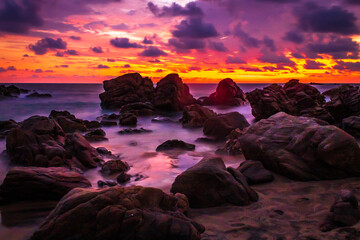 Wall Mural - beach with a lot of rocks at sunset, with cloudy sky in puerto escondido oaxaca 