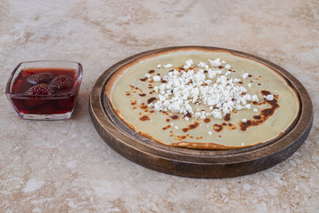 Wall Mural - A wooden board of homemade thin fresh crepes with strawberry jam