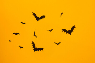 yellow background with black paper bats