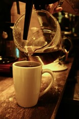 Canvas Print - Barista pouring filter coffee in a mug