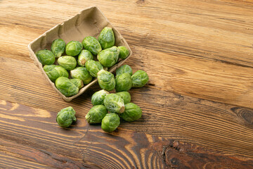 Wall Mural - Brussels Sprouts on Wood Background, Brassica Oleracea Cabbage Pile