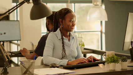 Poster - Business woman browsing internet on computer to work on report, creating startup presentation with research data charts and information on website. Using paperwork to send email.