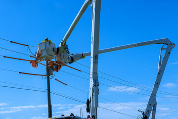 Wall Mural - As a result of storm, electrical workers in the power pole maintenance industry were hired to repair damaged power lines.