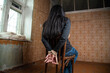 Woman tied up sitting on a chair